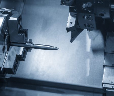 The  CNC lathe machine  cutting the sample bullet metal parts.